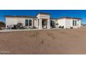 Modern single-story home exterior with front porch and desert landscaping at 34150 W Corleone Dr, Maricopa, AZ 85138