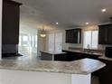 Modern kitchen with dark brown cabinets and granite countertops at 38007 W Mcdowell Rd, Tonopah, AZ 85354