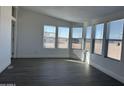 Bright living room featuring gray vinyl flooring and multiple windows at 38007 W Mcdowell Rd, Tonopah, AZ 85354