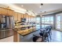 Gourmet kitchen with granite countertops and stainless steel appliances at 3888 E Hazeltine Way, Chandler, AZ 85249