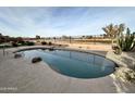 Kidney shaped pool with surrounding landscaping and a golf course view at 3888 E Hazeltine Way, Chandler, AZ 85249