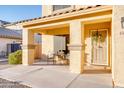 Covered porch with seating for two and a charming lemon wreath at 4340 E Silverbell Rd, San Tan Valley, AZ 85143