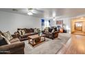 Spacious living room with hardwood floors, two sofas, and a wood-burning fireplace at 4340 E Silverbell Rd, San Tan Valley, AZ 85143