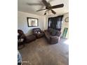 Living room featuring tiled floors and brown leather furniture at 5616 W Granada Rd, Phoenix, AZ 85035