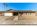 Single-story home with solar panels and a spacious front yard at 5732 W Purdue Ave, Glendale, AZ 85302