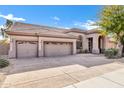 Two-car garage with decorative doors and neutral exterior at 6429 E Everett Dr, Scottsdale, AZ 85254