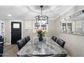 Elegant dining room featuring a large marble table and modern chandelier at 7837 N 13Th St, Phoenix, AZ 85020