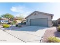 Grey stucco home with a two-car garage and drought-tolerant landscaping at 10359 E Morning Star Dr, Scottsdale, AZ 85255