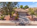 Single-story home with a tile roof, landscaped yard, and a two-car garage at 10387 W Runion Dr, Peoria, AZ 85382