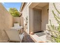 Small patio with a table and chairs, adjacent to the house entrance at 10387 W Runion Dr, Peoria, AZ 85382