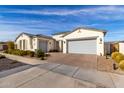 Well maintained home exterior, featuring a two-car garage and desert landscaping at 10712 E Trillium Ave, Mesa, AZ 85212