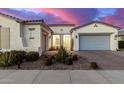 Stunning curb appeal featuring a two-car garage and drought-tolerant landscaping at 10712 E Trillium Ave, Mesa, AZ 85212