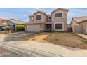 Two-story house with a large garage and landscaped yard at 11163 W Elm Ln, Avondale, AZ 85323