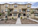 Three-story townhome with front yard landscaping and walkway at 1255 N Arizona Ave # 1341, Chandler, AZ 85225