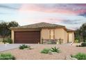 Tan stucco house with brown garage door, landscaping, and desert landscaping at 1443 W Hopi Dr, Coolidge, AZ 85128