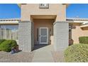 Front entrance with security door and brick columns at 14812 W Las Brizas Ln, Sun City West, AZ 85375