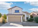 Two-story house with tan exterior and a two-car garage at 15857 W Yavapai St, Goodyear, AZ 85338