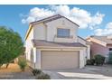 Two-story house with tan exterior and a two-car garage at 15857 W Yavapai St, Goodyear, AZ 85338