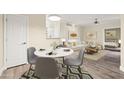 Dining area flows into a well-lit living room and showcases stylish decor and neutral color palette at 1701 E Colter St # 223, Phoenix, AZ 85016