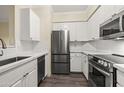 Stylish kitchen with stainless steel appliances and white cabinets provides a modern cooking space at 1701 E Colter St # 223, Phoenix, AZ 85016
