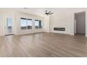 Bright and airy living room featuring tile floors, a fireplace, and plenty of natural light at 17017 W Baker Dr, Surprise, AZ 85387