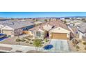 Single-story house, tile roof, two-car garage and nicely landscaped yard at 18216 W Foothill Dr, Surprise, AZ 85387