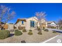 Charming one-story house with front yard landscaping and a two-car garage at 18216 W Foothill Dr, Surprise, AZ 85387