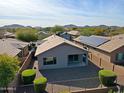 Backyard view showing a patio, gravel landscaping and solar panels at 1828 W Owens Way, Anthem, AZ 85086