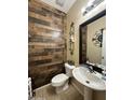 Modern bathroom with wood-look tile and updated vanity at 18656 W Raymond St, Goodyear, AZ 85338