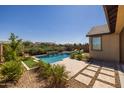 Inviting backyard oasis with a sparkling pool and patio at 19447 S 209Th Pl, Queen Creek, AZ 85142