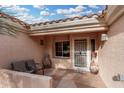 Covered patio with seating area near the front entrance at 20426 N 133Rd Dr, Sun City West, AZ 85375