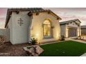 Charming home exterior with arched window, manicured turf, and desert landscaping at 22901 E Quintero Rd, Queen Creek, AZ 85142