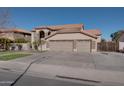 Beautiful two-story home with a three-car garage, manicured lawn, and desert landscaping at 2848 E Menlo St, Mesa, AZ 85213