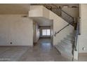 Elegant foyer showcasing tile flooring, a staircase with wrought iron railings, and neutral wall tones at 2848 E Menlo St, Mesa, AZ 85213