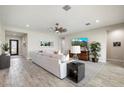 Spacious living room with tile floors and large TV at 3015 E Daley Ln, Phoenix, AZ 85050