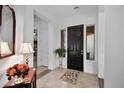 Bright and airy entryway with a dark wood accent table and fresh flowers at 30224 N 52Nd Pl, Cave Creek, AZ 85331