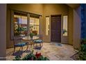 Charming courtyard entry with tiled flooring, metal table and chairs, and lush flowers at 30224 N 52Nd Pl, Cave Creek, AZ 85331