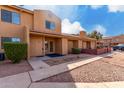 Front view of a two-story condo with a walkway and desert landscaping at 3511 E Baseline Rd # 1210, Phoenix, AZ 85042