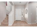 Bright entryway with tiled floors, staircase, and neutral walls at 3703 W Mccauley Ct, Phoenix, AZ 85086