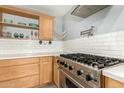 Stainless steel gas range and white subway tile backsplash in a light wood kitchen at 4028 W Palo Verde Dr, Phoenix, AZ 85019