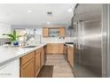 Modern kitchen with light wood cabinets, stainless steel appliances, and an island at 4028 W Palo Verde Dr, Phoenix, AZ 85019