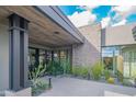 Private courtyard entry with stone wall, modern lighting, and drought-tolerant landscaping at 41104 N 96Th St, Scottsdale, AZ 85262