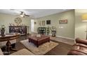 Spacious living room with hardwood floors and a large ceiling fan at 43579 W Arizona Ave, Maricopa, AZ 85138