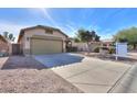 Front view of a house with a two-car garage and a well-maintained yard at 45091 W Cypress Ln, Maricopa, AZ 85139