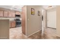 A modern kitchen with stainless steel appliances and wood cabinets at 4572 E Silverbell Rd, San Tan Valley, AZ 85143