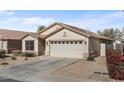 One-story house featuring a two-car garage and drought-tolerant landscaping at 45762 W Dirk St, Maricopa, AZ 85139