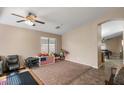 Bright and spacious living room with neutral colors and tiled floors at 45762 W Dirk St, Maricopa, AZ 85139