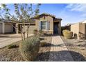 House exterior showcasing a walkway to the front entrance and landscaping at 4816 S 117Th Ave, Avondale, AZ 85323