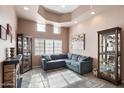 Cozy sitting area with a comfortable sectional sofa and display cases at 5540 E Shea Blvd, Scottsdale, AZ 85254