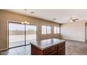 Dining area with island, tile flooring, a sliding glass door, and views of the backyard at 6102 S 37Th Ln, Phoenix, AZ 85041